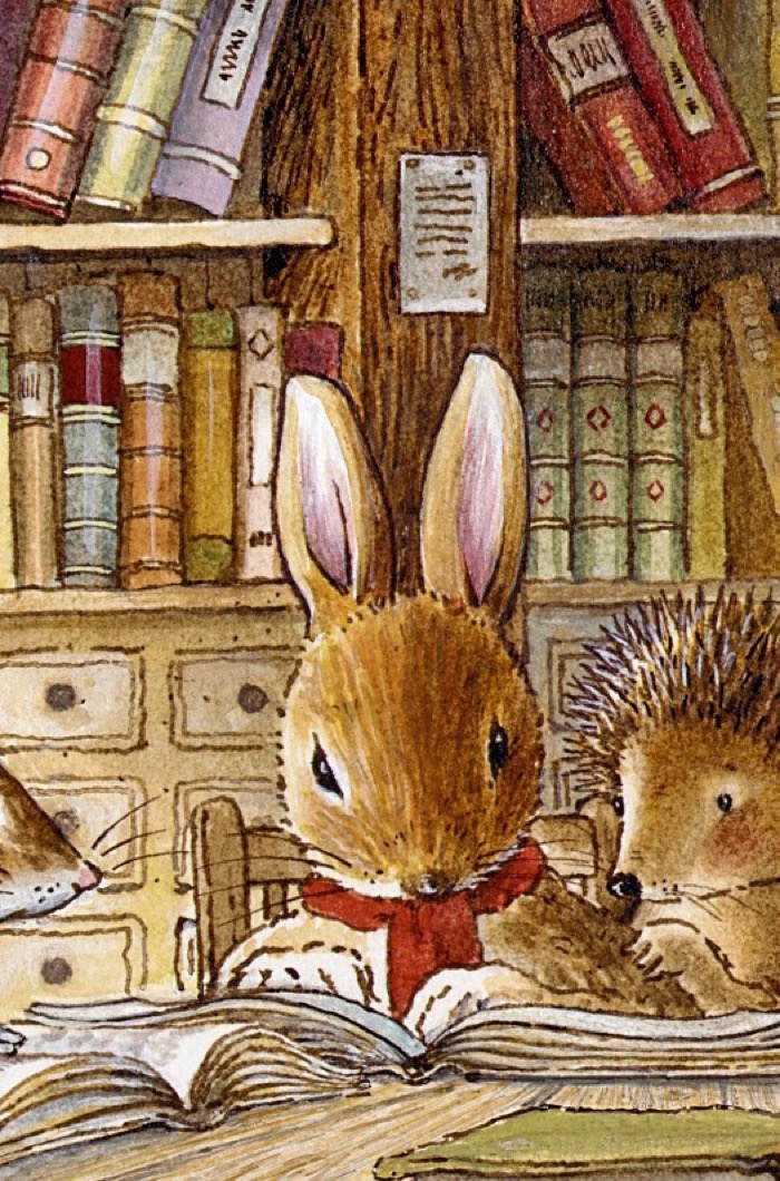 Rue Rabbit with a red neckerchief reading an open book in the study